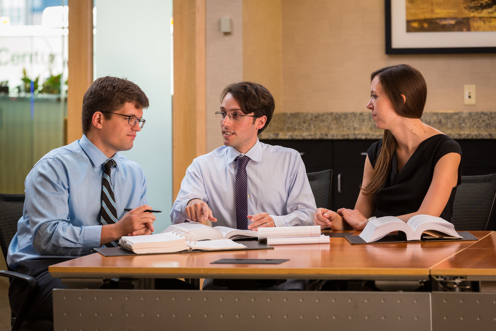 Evan, Elliot, and Erin sitting at a desk