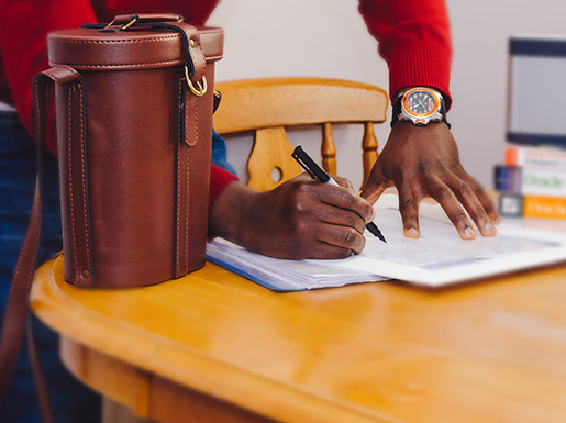 A person signing paperwork