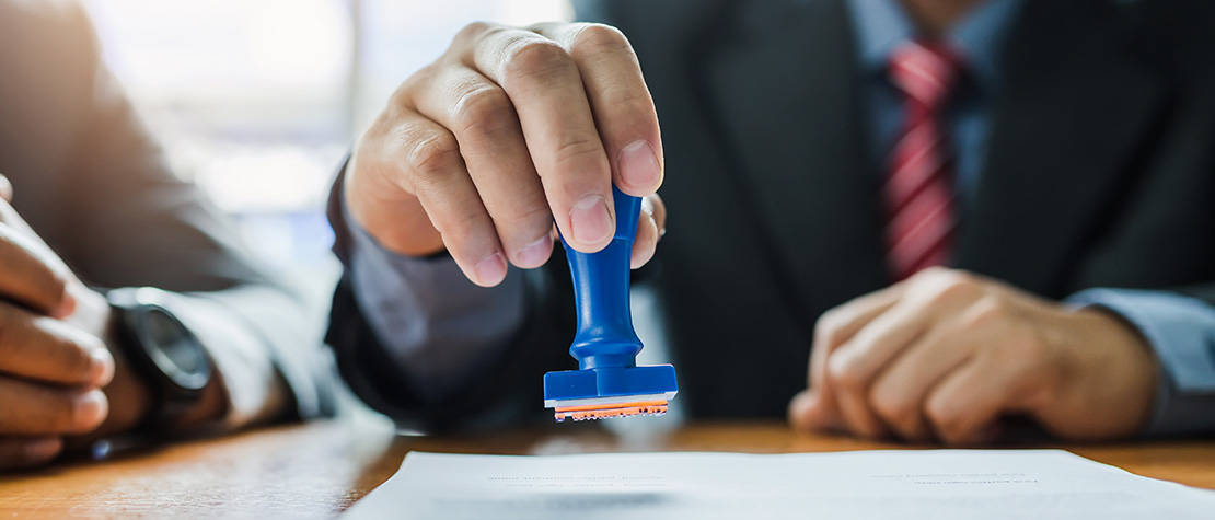 A worker stamping a paper