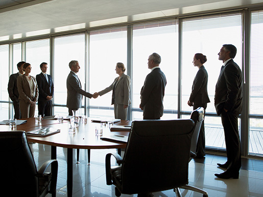 a bunch of business people in a meeting room