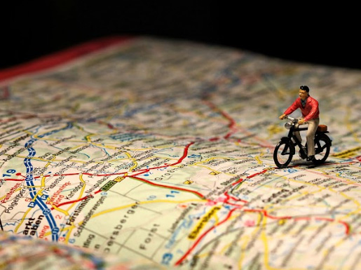 A toy person on a bicycle on a road map