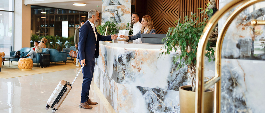 A man checking into a hotel